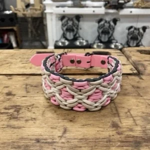 Halsband für Hunde aus dem Material Paracord. Das Halsband hat ein Biothane Adapter. Das Halsband ist in zwei verschiedenen braun Tönen und einem rosa Ton.